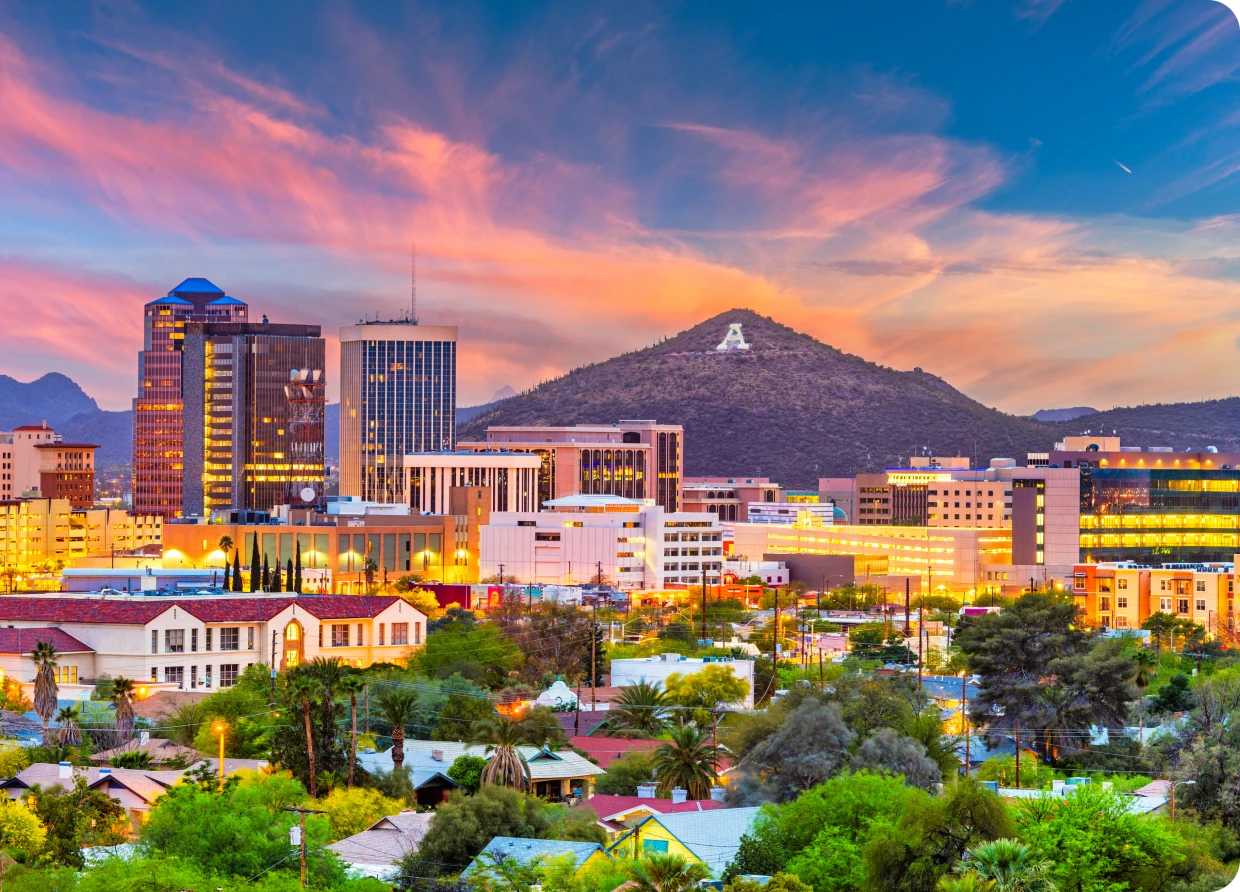 Colorful sunset over Tucson cityscape and mountains.